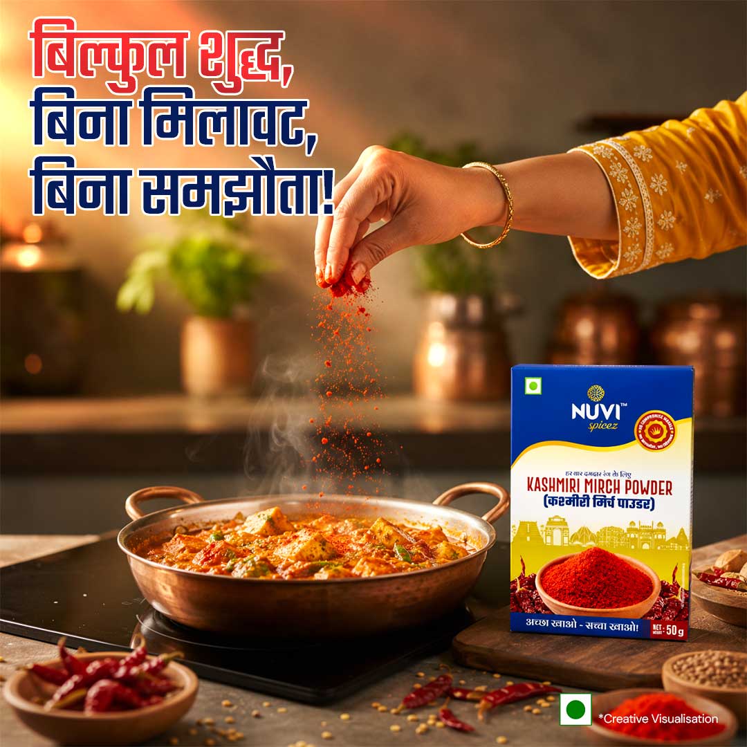 Kashmiri Red Chilli Powder being sprinkled into a pot of curry for vibrant flavor and color